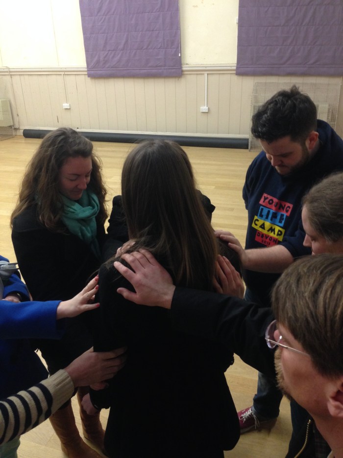 The team praying for Hannah before she gave her talk at Club.